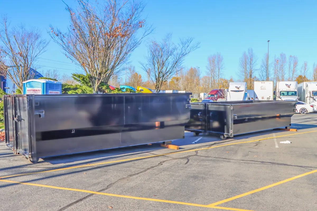 Professional dumpster rental service with roll-off container on residential driveway in Vienna